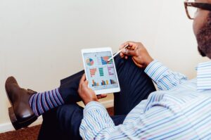 A business man interacting with a tablet to represent how to Prove ROI—The Question Marketing Can't Answer?